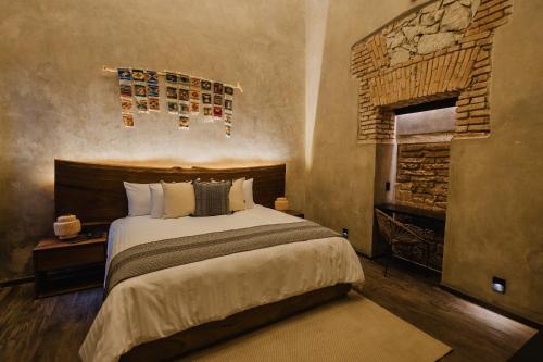 a bedroom with a large bed and a fireplace at Casa Levonka in Oaxaca City