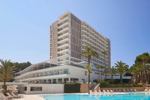 a large building with a pool in front of it at Meliá Calviá Beach in Magaluf