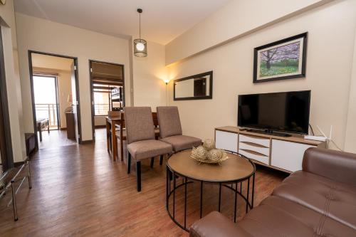a living room with a couch and a television at 2BR Cloud 512 with Parking Slot in Baguio