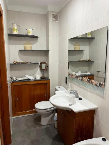 a bathroom with a toilet and a sink at Can Mariano in Mollet de Perelada