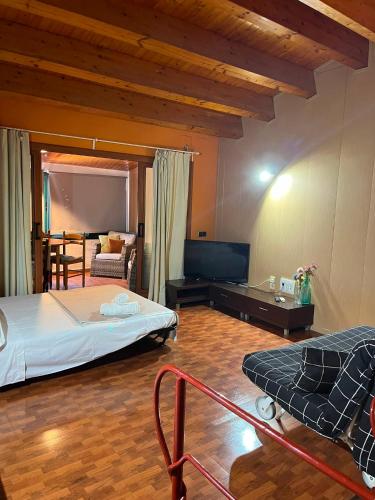 a bedroom with a bed and a couch in a room at Can Mariano in Mollet de Perelada