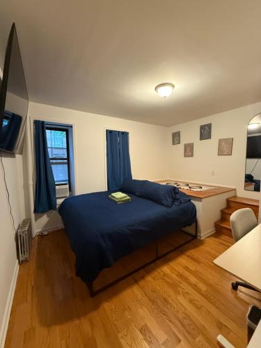 a bedroom with a bed and a desk in it at The atlas - Shared apartment in New York