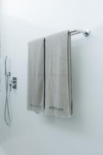 a towel hanging on a towel rack in a bathroom at Sojourn in Tumbak Bayuh