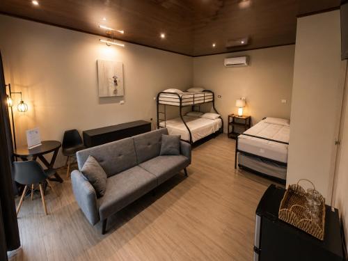 a living room with two bunk beds and a couch at Villas Na-tiva Guanacaste in Plazuela