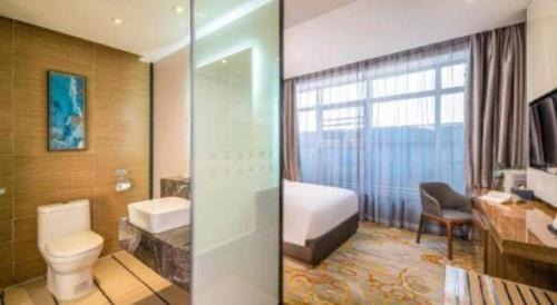 two pictures of a bathroom with a toilet and a sink at Nanning Champs Elysees Hotel in Nanning