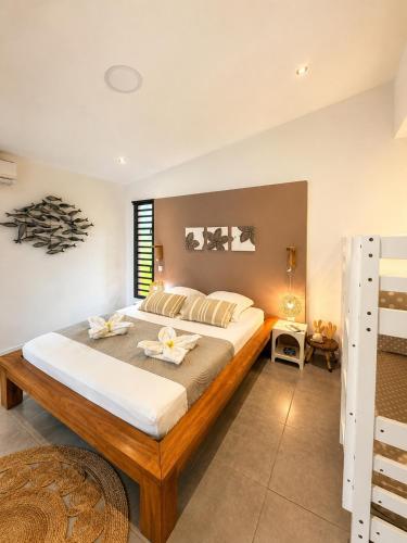 a bedroom with a large bed in a room at Lilie Location Sapotis in Saint-Joseph