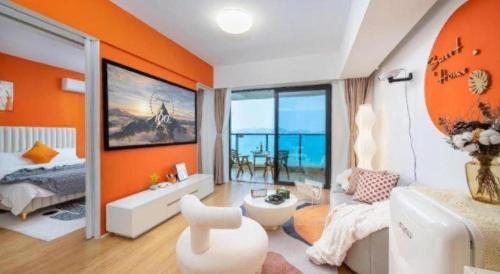 a room with orange walls and a bedroom with a bed at BOOK PAVILION HOTEL in Dongguan