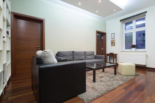 
a living room with a couch and a coffee table at Apartments Zagreb Point - Vinogradska in Zagreb
