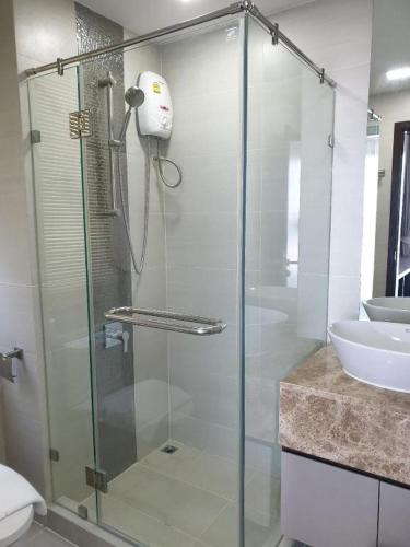 a glass shower in a bathroom with a sink at The High One in Ban Laem Thaen