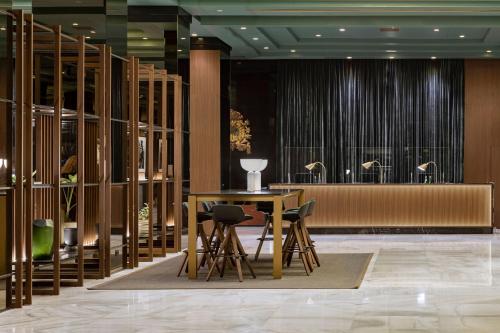 a lobby with a table and chairs in a building at Meliá Milano in Milan