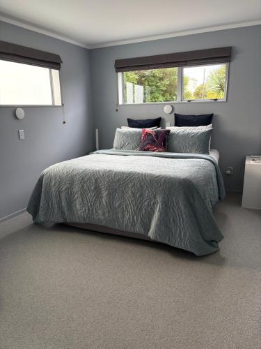 a bedroom with a bed and a window at Mason lane Apartment in Whangarei