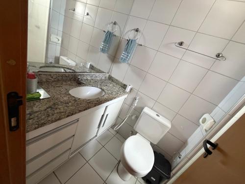a small bathroom with a toilet and a sink at Garden aconchegante in Manaus
