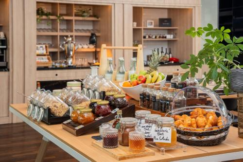 a table with many different types of food on it at INNSiDE by Meliá Düsseldorf Seestern in Düsseldorf