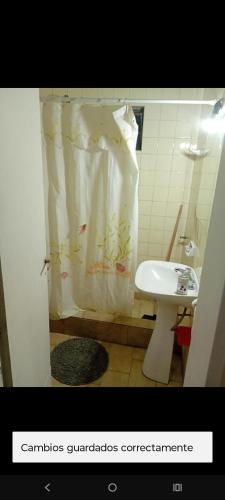 a bathroom with a shower curtain and a sink at Memento Vivere Boutique rooms in Neuquén