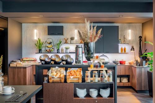 a kitchen with a counter with food on it at INNSiDE by Meliá Düsseldorf Hafen in Düsseldorf
