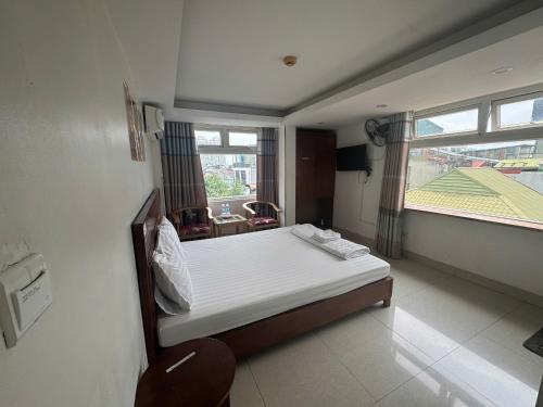 a small bedroom with a bed and a window at Hanoi Gold Hotel Near Bach Mai in Hanoi
