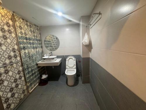 a small bathroom with a toilet and a sink at Hanoi Gold Hotel Near Bach Mai in Hanoi