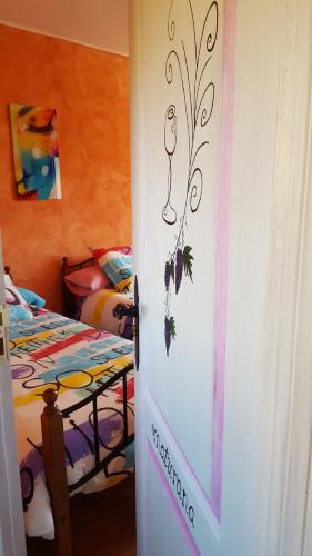 a door leading to a room with two beds at Hostal A La Sombra Del Laurel in Navarrete
