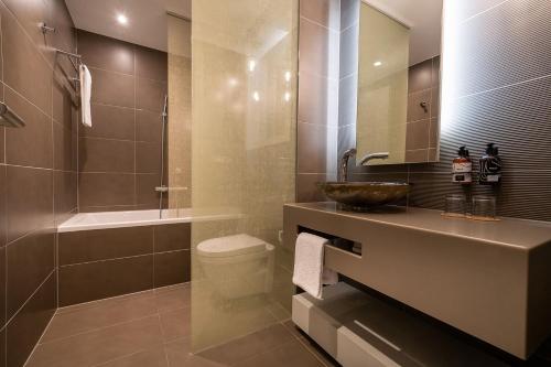 a bathroom with a sink and a toilet and a shower at INNSiDE by Meliá Prague Old Town in Prague