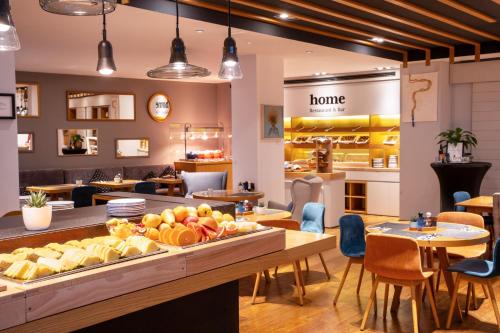 a restaurant with a counter with fruit on it at INNSiDE by Meliá Prague Old Town in Prague