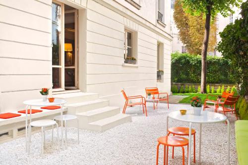 a patio with tables and chairs next to a building at Meliá Paris Champs Elysées in Paris