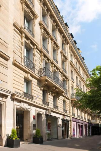 a large building with balconies on the side of it at Meliá Paris Champs Elysées in Paris