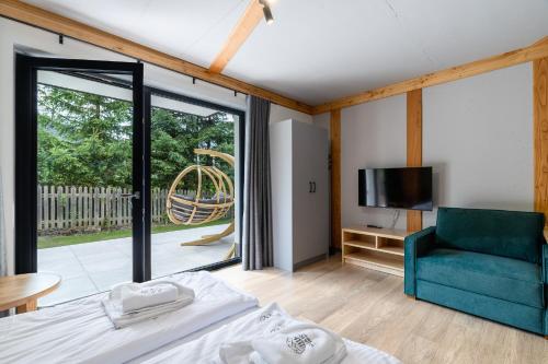 a bedroom with a bed and a sliding glass door at Willa Folc in Kościelisko