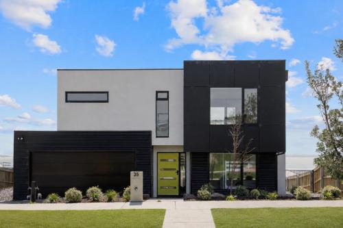 a modern house with a black and white facade at The Bay View San Remo by Ready Set Stay- BYO LINEN & TOWELS in San Remo