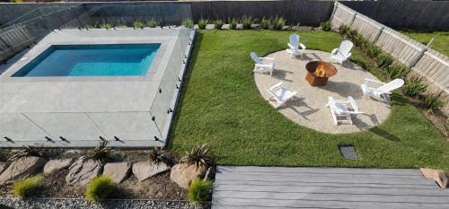 an aerial view of a backyard with a swimming pool and chairs at The Bay View San Remo by Ready Set Stay- BYO LINEN & TOWELS in San Remo