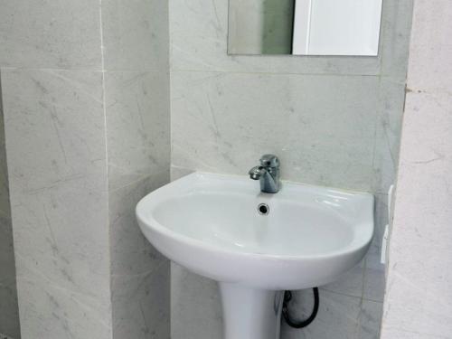 a white sink in a bathroom with a mirror at SOPHIA Hotel Ureki in Ureki
