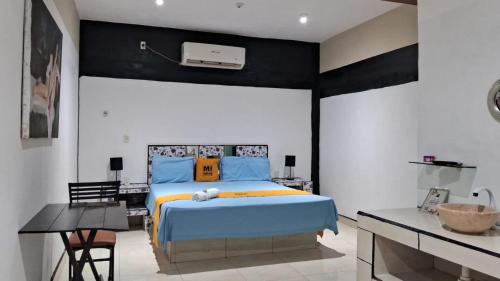a bedroom with a large bed with blue and orange pillows at Mi Hotel Club in Lázaro Cárdenas