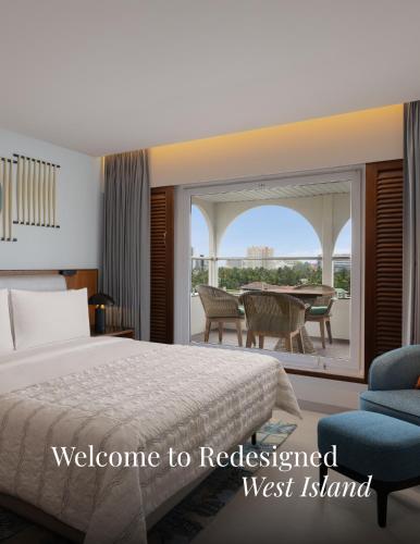 a hotel room with a bed and a balcony at Le Meridien Kochi in Cochin