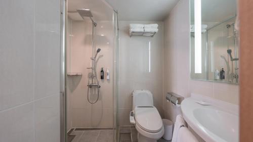 a bathroom with a shower and a toilet and a sink at Central Seven Hotel by Kwon Busan Seomyeon in Busan