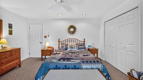 a bedroom with a bed and two dressers and a door at Uncas by AvantStay in North Creek