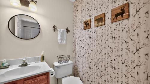 a bathroom with a toilet and a sink and a mirror at Uncas by AvantStay in North Creek