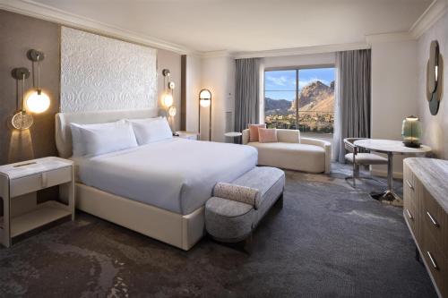 a bedroom with a bed and a living room at Hilton Lake Las Vegas Resort & Spa in Las Vegas