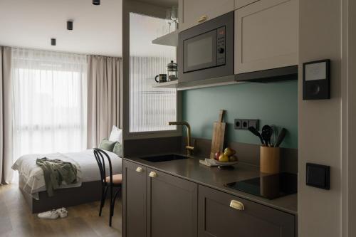 a kitchen with a sink and a bed in a room at Bob W Vienna Döbling in Vienna