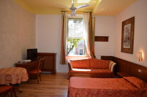 a hotel room with a bed and a window at Albergo Ristorante Da Giuseppe in Copparo
