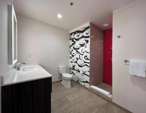 a bathroom with a sink and a toilet and a shower at Ahern Hotel and Event Center in Las Vegas