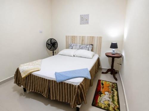 a small bedroom with a bed and a table at Vista colonial suite in Comayagua