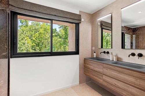 a bathroom with a sink and a large window at Villa Augusta in Tourrettes