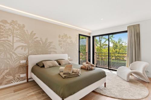 a bedroom with a bed and a large window at Villa Augusta in Tourrettes