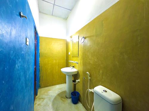 a bathroom with a sink and a toilet at Splendid Lake View Safari Lodge in Udawalawe