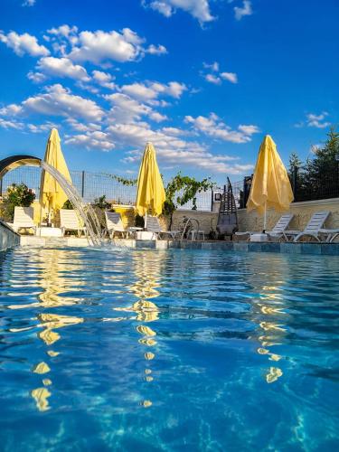 a swimming pool with a fountain in the water at İncebey Konak Cappadocia Swimming Pool in Uçhisar