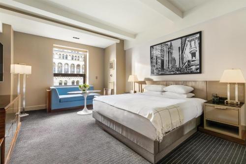 a hotel room with a large bed and a desk at Hyatt Grand Central New York in New York