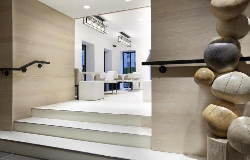a lobby with stairs and chairs in a building at Hyatt Grand Central New York in New York