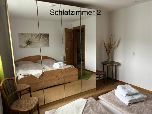 a mirror in a bedroom with a bed in it at Ferienwohnung Anke Kaufmann in Miltenberg