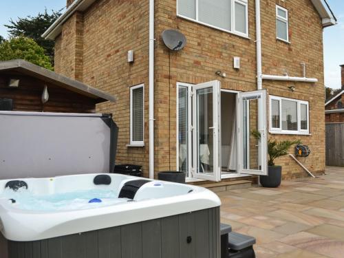 a hot tub on a patio in front of a house at Oceans 44 in Bridlington