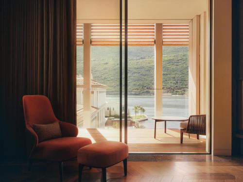 a room with a large window with a view of the ocean at One&Only Portonovi in Herceg-Novi