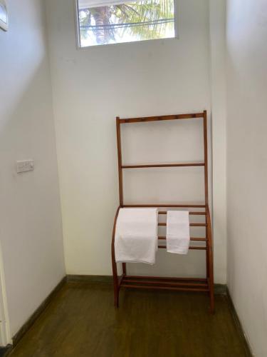 a chair in a room with two towels at Sea Tide by Jade Rock in Negombo